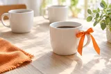 Concept image of coffee cups and an orange ribbon for community conversation