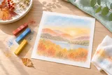 Illustrative still life of pastels and an autumn-colored drawing